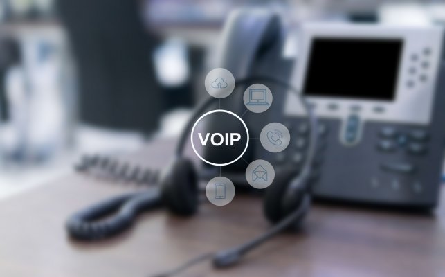 axvoice voip service overview voip voip symbols icons and voip phone on desk office blurred in the background